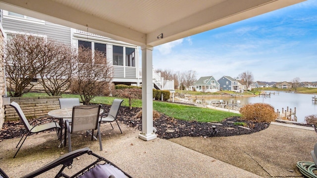 view of patio featuring outdoor dining area, a water view, and a residential view