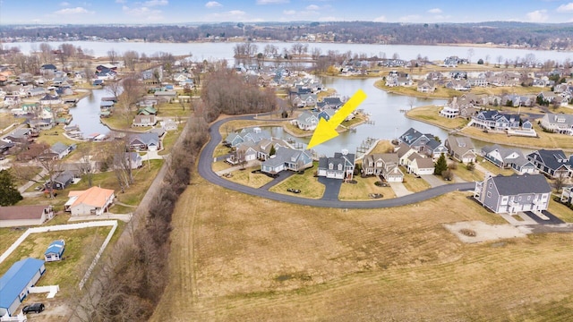 birds eye view of property featuring a water view and a residential view