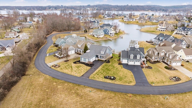 drone / aerial view featuring a residential view and a water view