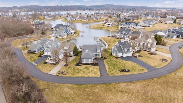 birds eye view of property with a water view and a residential view