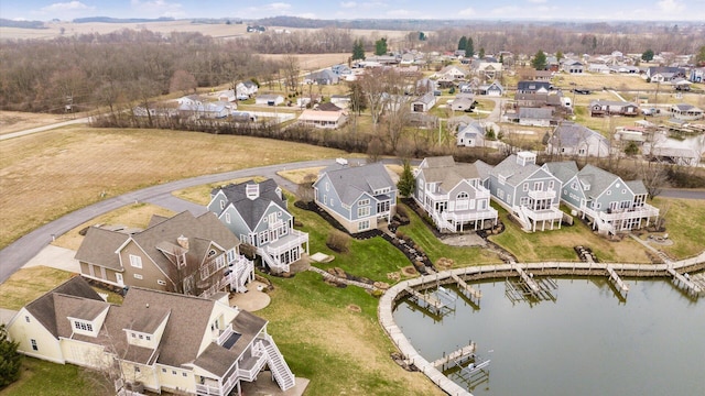 birds eye view of property featuring a water view and a residential view