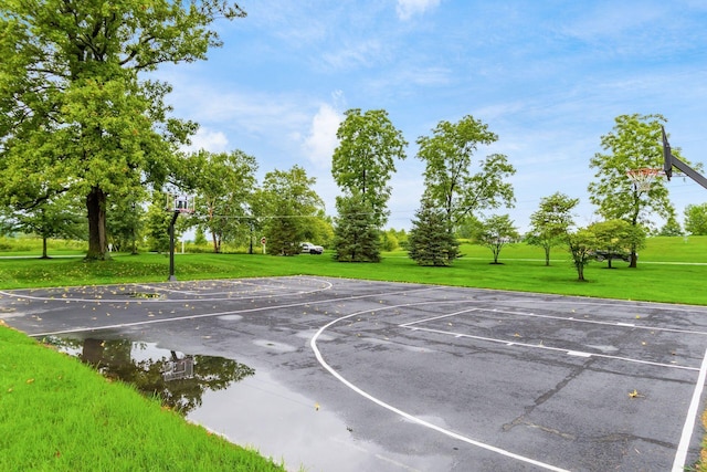 view of basketball court featuring community basketball court and a lawn