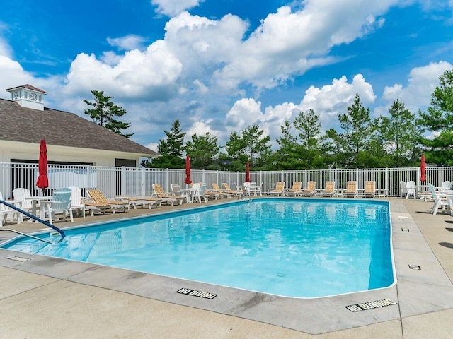 view of pool featuring a patio area and fence