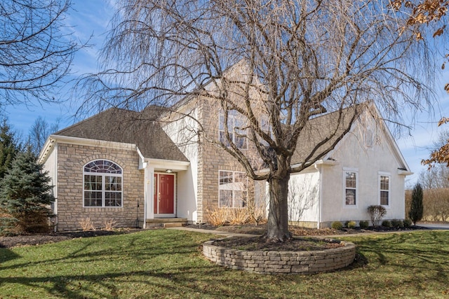 view of front of home featuring a shingled roof, a front yard, stone siding, and stucco siding