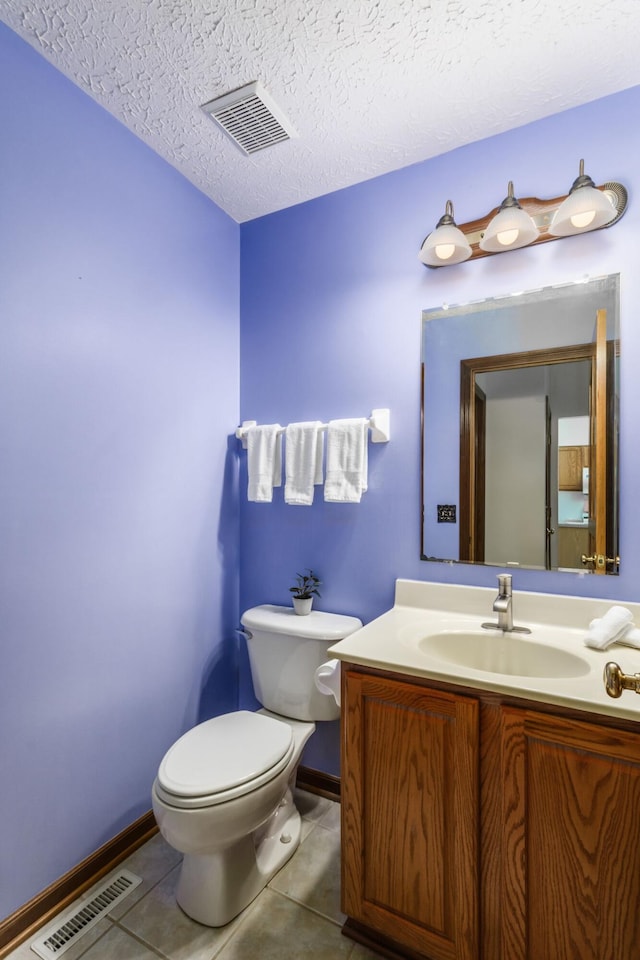 bathroom featuring visible vents, a textured ceiling, toilet, and tile patterned floors