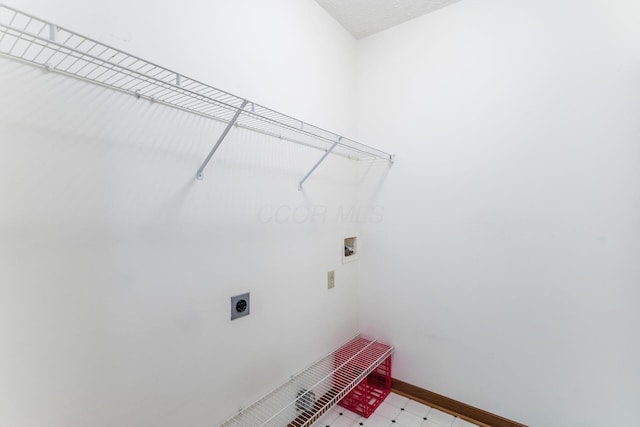 laundry room with hookup for an electric dryer, laundry area, washer hookup, baseboards, and light floors