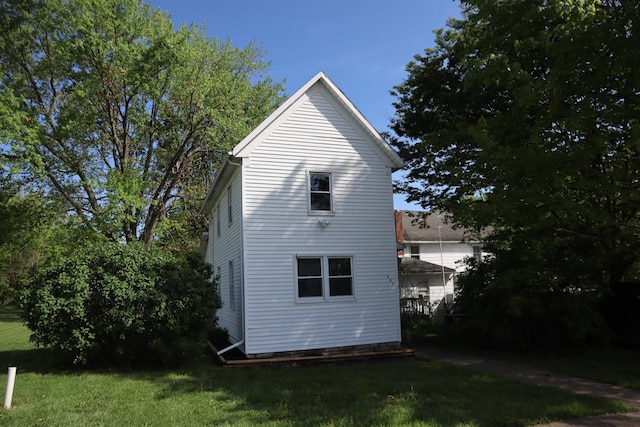 view of side of property with a lawn