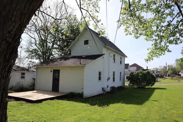 rear view of house with central air condition unit, a yard, and a deck