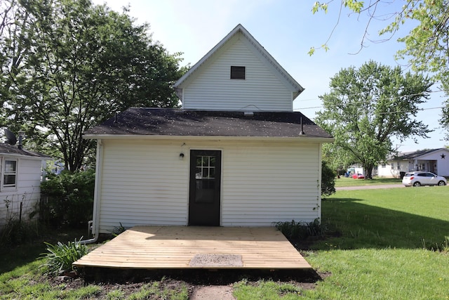 rear view of house with a lawn and a deck