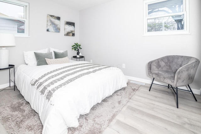 bedroom featuring baseboards and wood finished floors