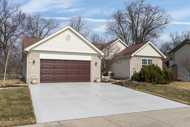 ranch-style house with a garage and stone siding