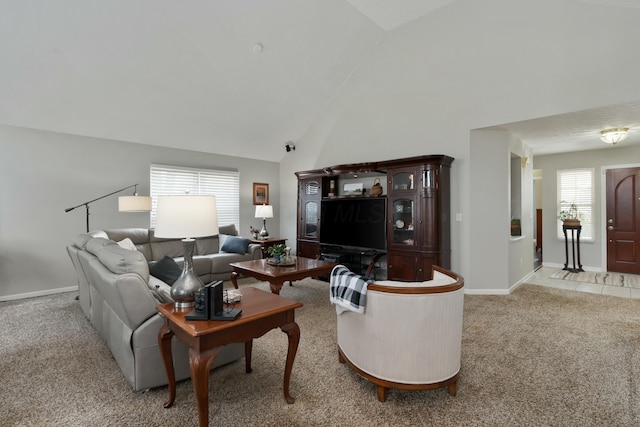 living room with high vaulted ceiling, carpet, and baseboards