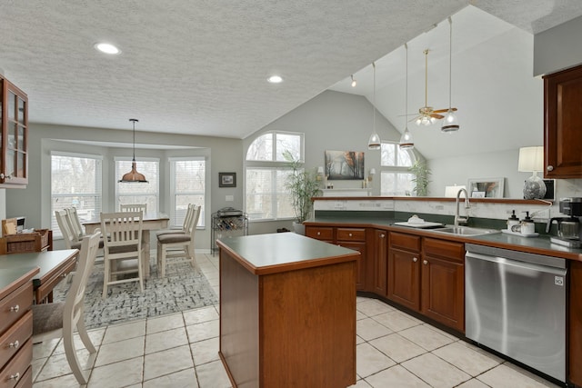 kitchen featuring a sink, light tile patterned floors, plenty of natural light, and stainless steel dishwasher