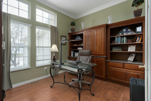 office space featuring ornamental molding, visible vents, light wood-style flooring, and baseboards