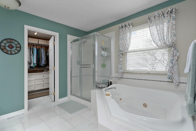 full bathroom featuring a stall shower, baseboards, a spacious closet, and a whirlpool tub