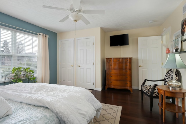 bedroom featuring visible vents, ceiling fan, a textured ceiling, wood finished floors, and baseboards