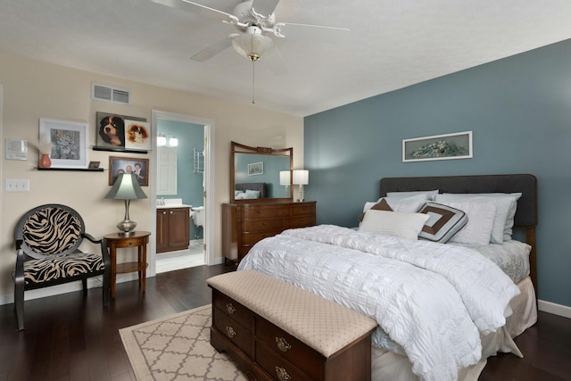 bedroom with visible vents, dark wood-type flooring, a ceiling fan, connected bathroom, and baseboards