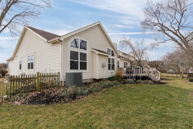 view of home's exterior with a yard, cooling unit, fence, and a wooden deck