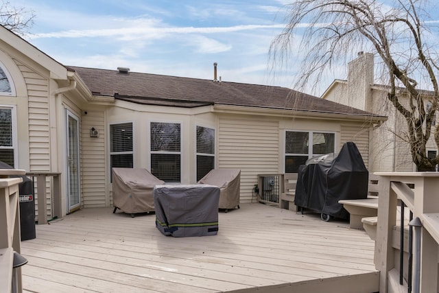 wooden deck featuring a grill