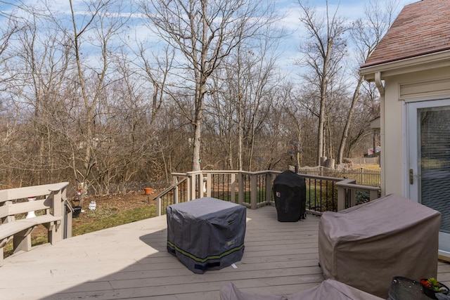 wooden terrace featuring a grill