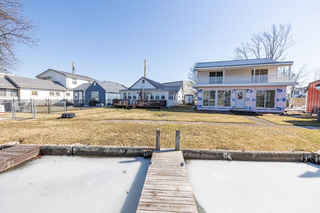 127 Brads Way, Russells Point, OH 43348 - exterior space featuring a lawn, a standing seam roof, metal roof, a balcony, and fence