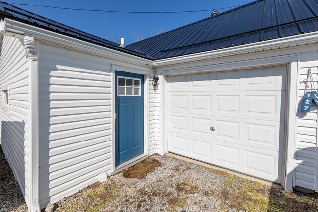 127 Brads Way, Russells Point, OH 43348 - entrance to property featuring a garage, metal roof, and driveway