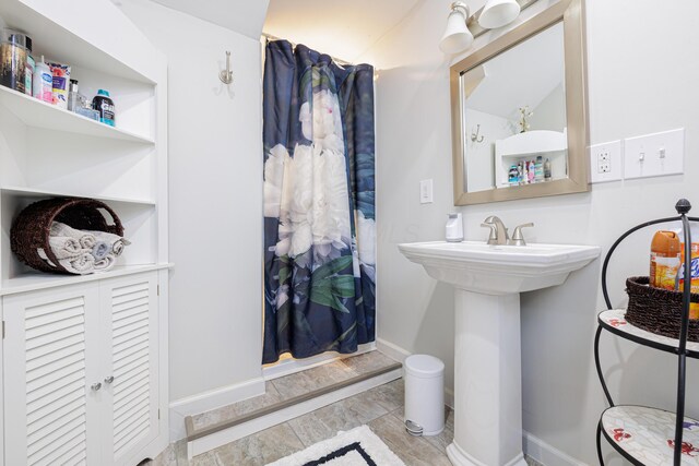 127 Brads Way, Russells Point, OH 43348 - full bathroom featuring baseboards, a sink, and a shower with shower curtain