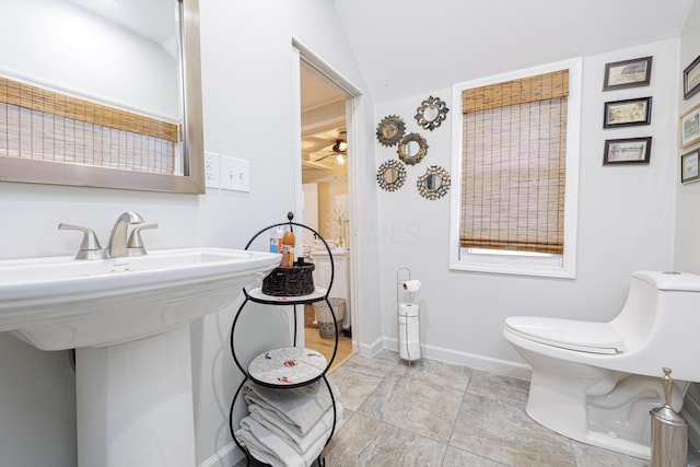 127 Brads Way, Russells Point, OH 43348 - bathroom featuring lofted ceiling, toilet, a sink, ceiling fan, and baseboards