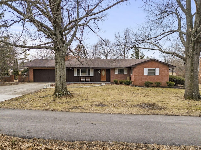 single story home with a garage, driveway, and brick siding