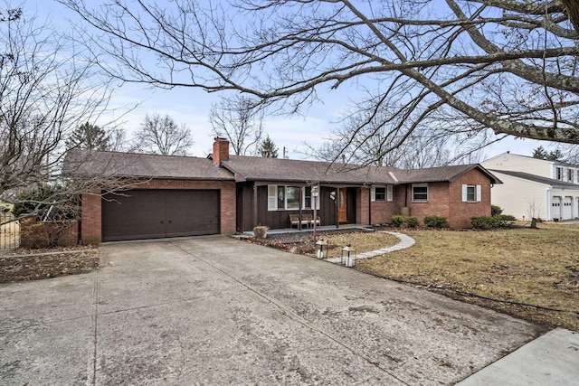 ranch-style home with a garage, a chimney, concrete driveway, and brick siding