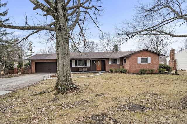 ranch-style home featuring a garage, concrete driveway, and brick siding