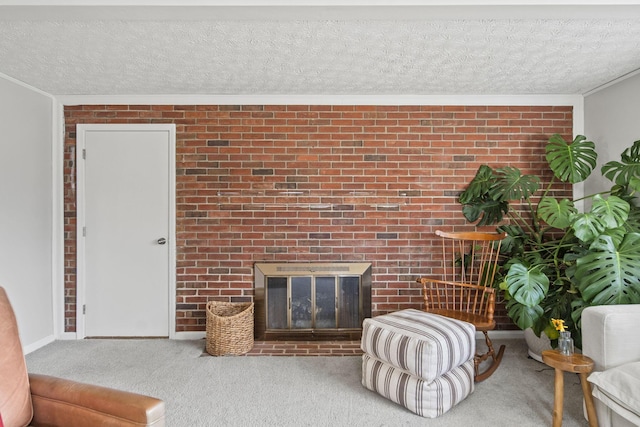 carpeted living room with a textured ceiling, brick wall, ornamental molding, and a brick fireplace