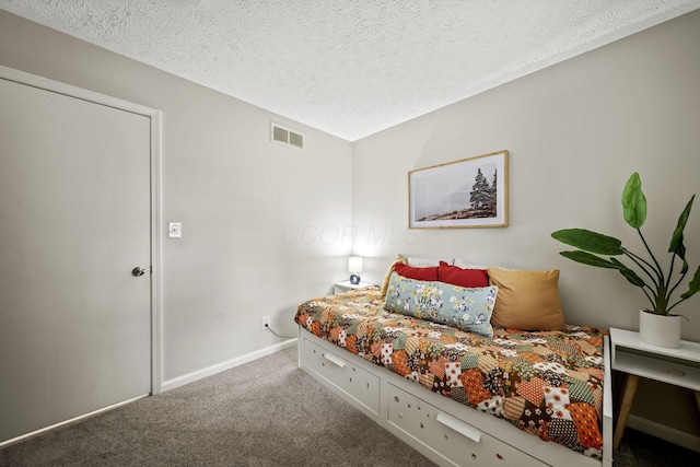 bedroom with a textured ceiling, carpet floors, visible vents, and baseboards