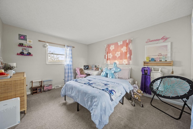 carpeted bedroom with baseboards, visible vents, and a textured ceiling