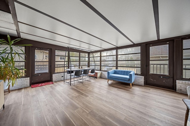 unfurnished sunroom featuring lofted ceiling