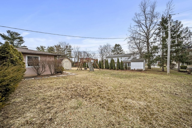 view of yard featuring an outbuilding and a storage shed