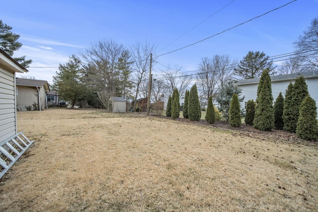 view of yard featuring an outbuilding and a shed