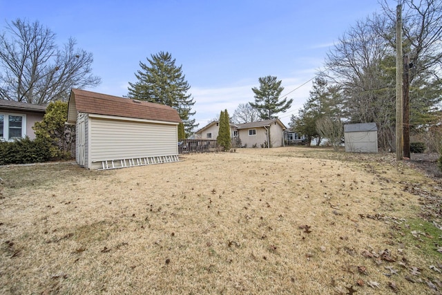 view of yard with a shed and an outbuilding