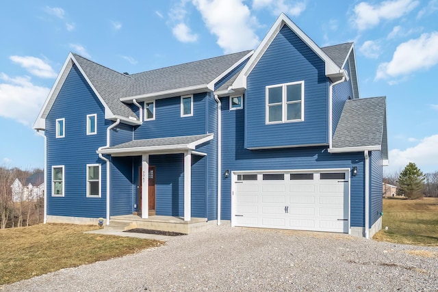 traditional home featuring an attached garage, a shingled roof, a front lawn, and gravel driveway