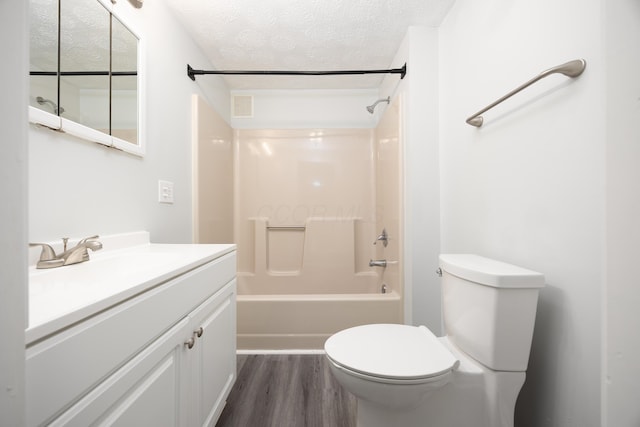 full bathroom with a textured ceiling, toilet, wood finished floors, vanity, and visible vents