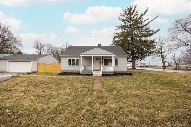 bungalow-style house with a porch, a front yard, fence, and a garage