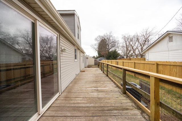 wooden terrace featuring fence