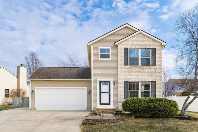 traditional-style house with a garage, concrete driveway, brick siding, and fence