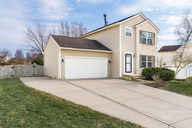 traditional-style home featuring concrete driveway, an attached garage, fence, and a front yard