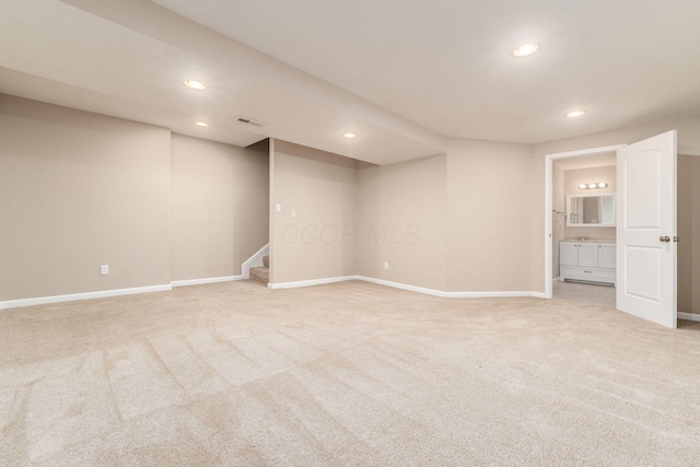 interior space featuring recessed lighting, light colored carpet, visible vents, and stairs