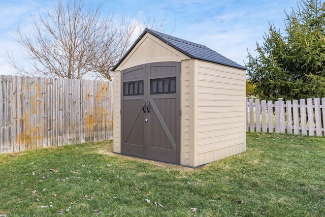 view of shed featuring a fenced backyard