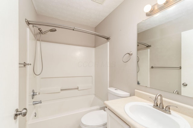 bathroom featuring toilet, tub / shower combination, a textured ceiling, and vanity