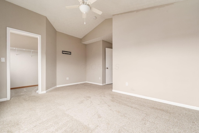 unfurnished bedroom with light carpet, baseboards, a closet, and lofted ceiling