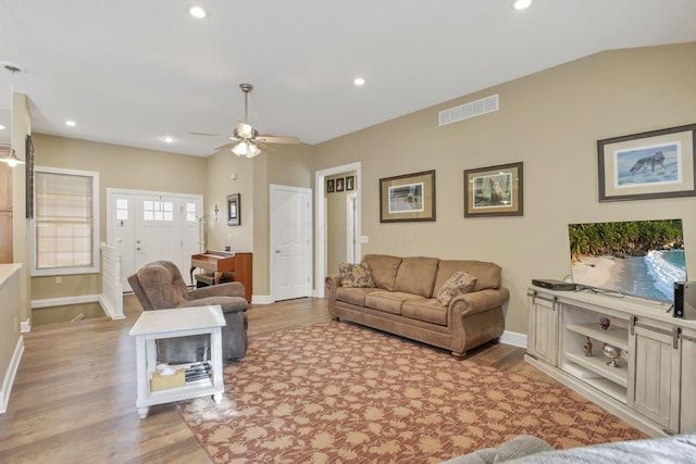 living area featuring recessed lighting, visible vents, baseboards, and wood finished floors