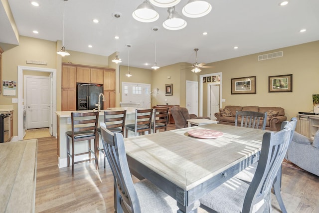 dining room with light wood-style floors, visible vents, a ceiling fan, and recessed lighting